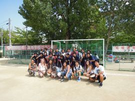 Large group of students in soccer field after a friendly game