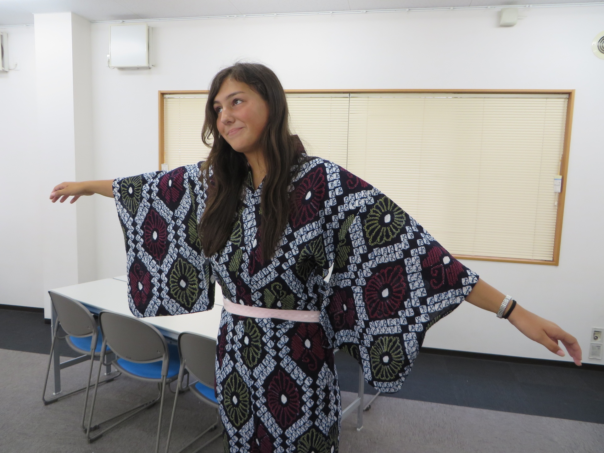 Student trying on kimono in classroom
